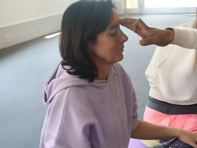 Yoga retreat participants in Rishikesh with Himalayan mountains in background